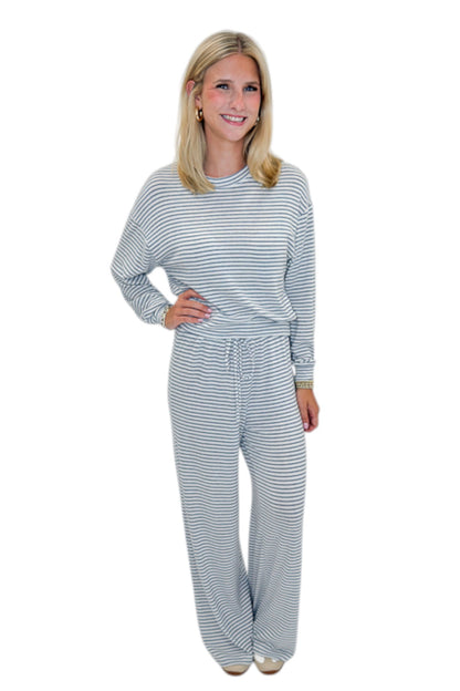 Front view of woman wearing Swagger Boutique’s Eclipse Classic Stripe Pants by Z Supply with Long Sleeve Top against white studio background.