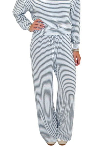 Front view of woman wearing Swagger Boutique’s Eclipse Classic Stripe Pants by Z Supply with Long Sleeve Top against white studio background.