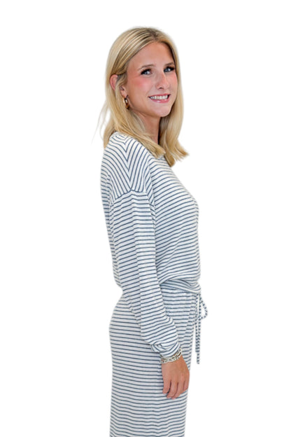 Side view of woman wearing Swagger Boutique’s Eclipse Classic Stripe Pants by Z Supply with Long Sleeve Top against white studio background.