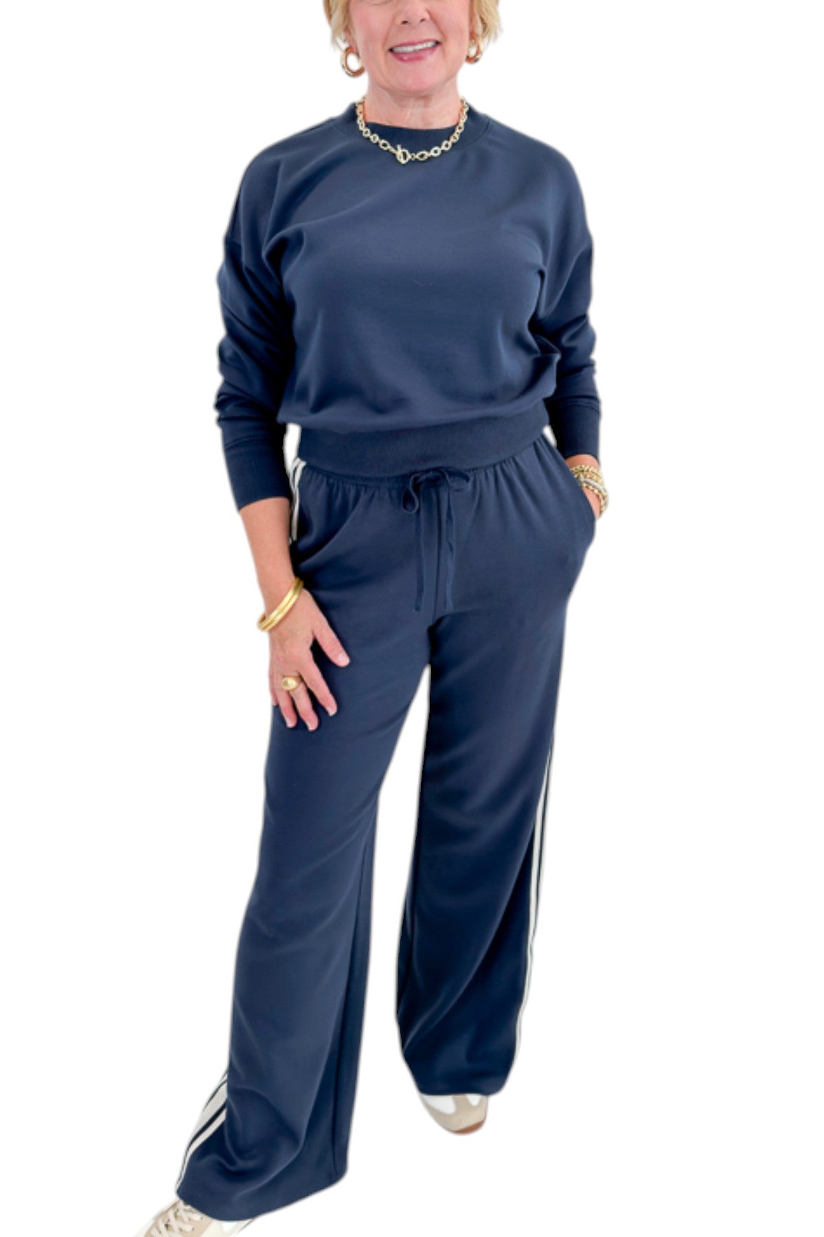 Front view of woman wearing Swagger Boutique’s Eclipse Breakaway Track Pants by Z Supply with Eclipse Comeback Sweatshirt by Z Supply against white studio background.