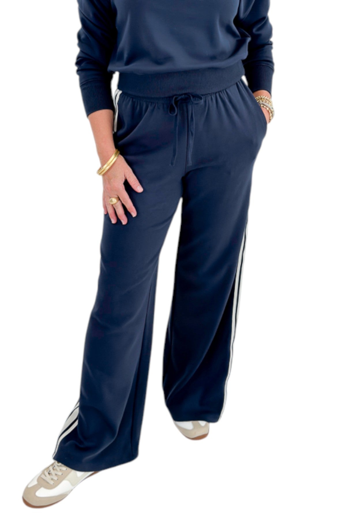 Front view of woman wearing Swagger Boutique’s Eclipse Breakaway Track Pants by Z Supply with Eclipse Comeback Sweatshirt by Z Supply against white studio background.