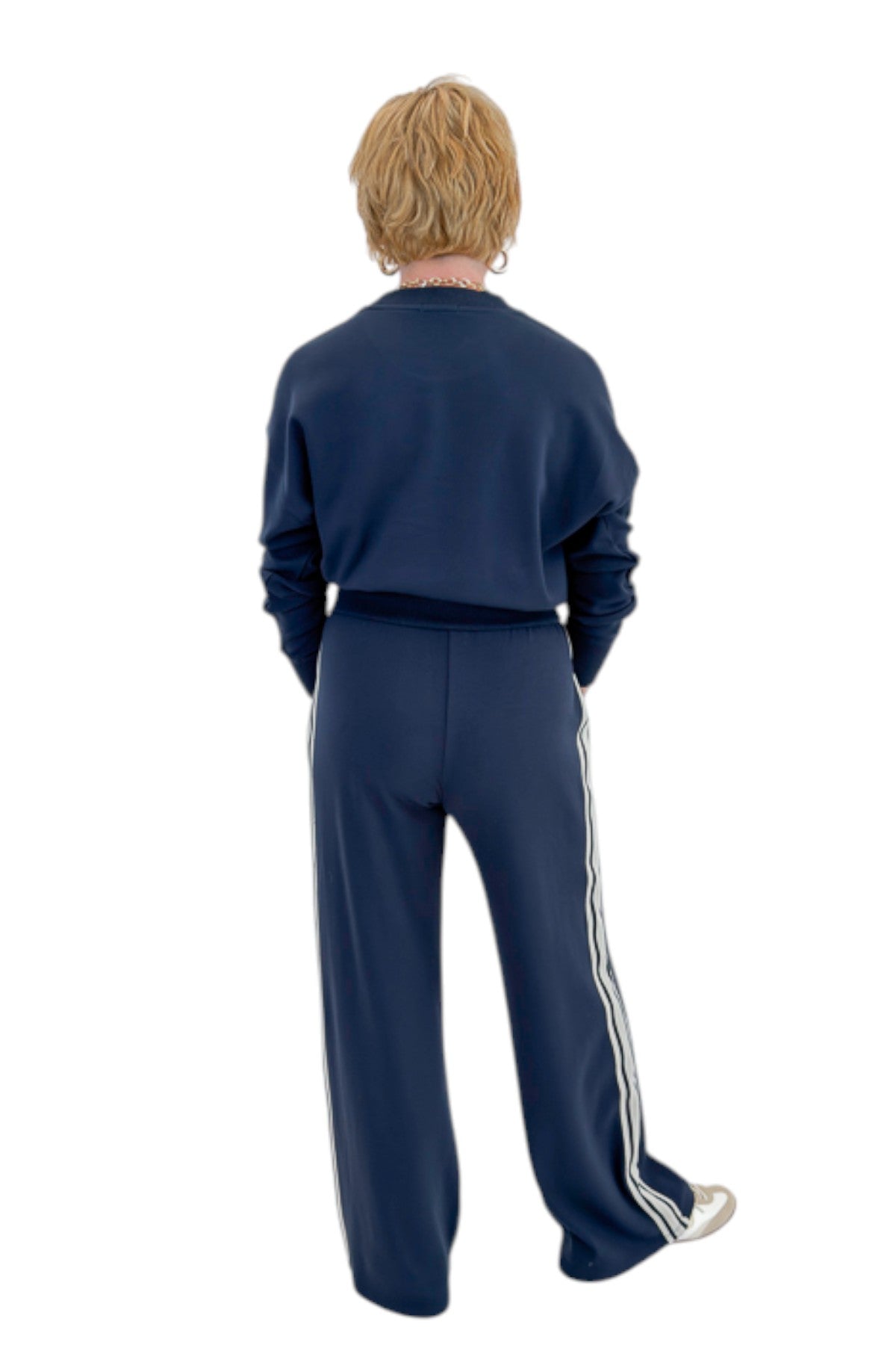 Back view of woman wearing Swagger Boutique’s Eclipse Breakaway Track Pants by Z Supply with Eclipse Comeback Sweatshirt by Z Supply against white studio background.