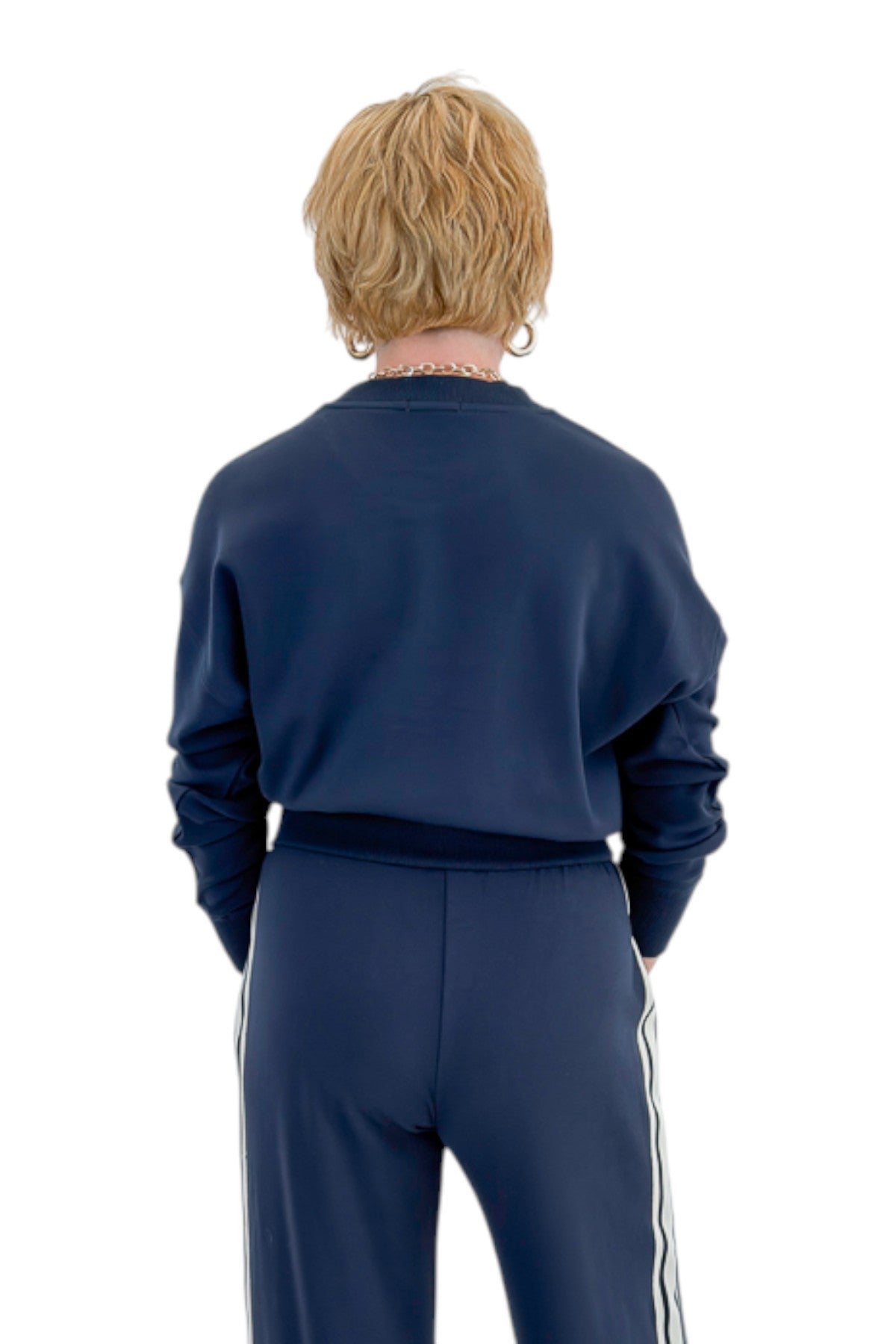 Back view of woman wearing Swagger Boutique’s Eclipse Breakaway Track Pants by Z Supply with Eclipse Comeback Sweatshirt by Z Supply against white studio background.