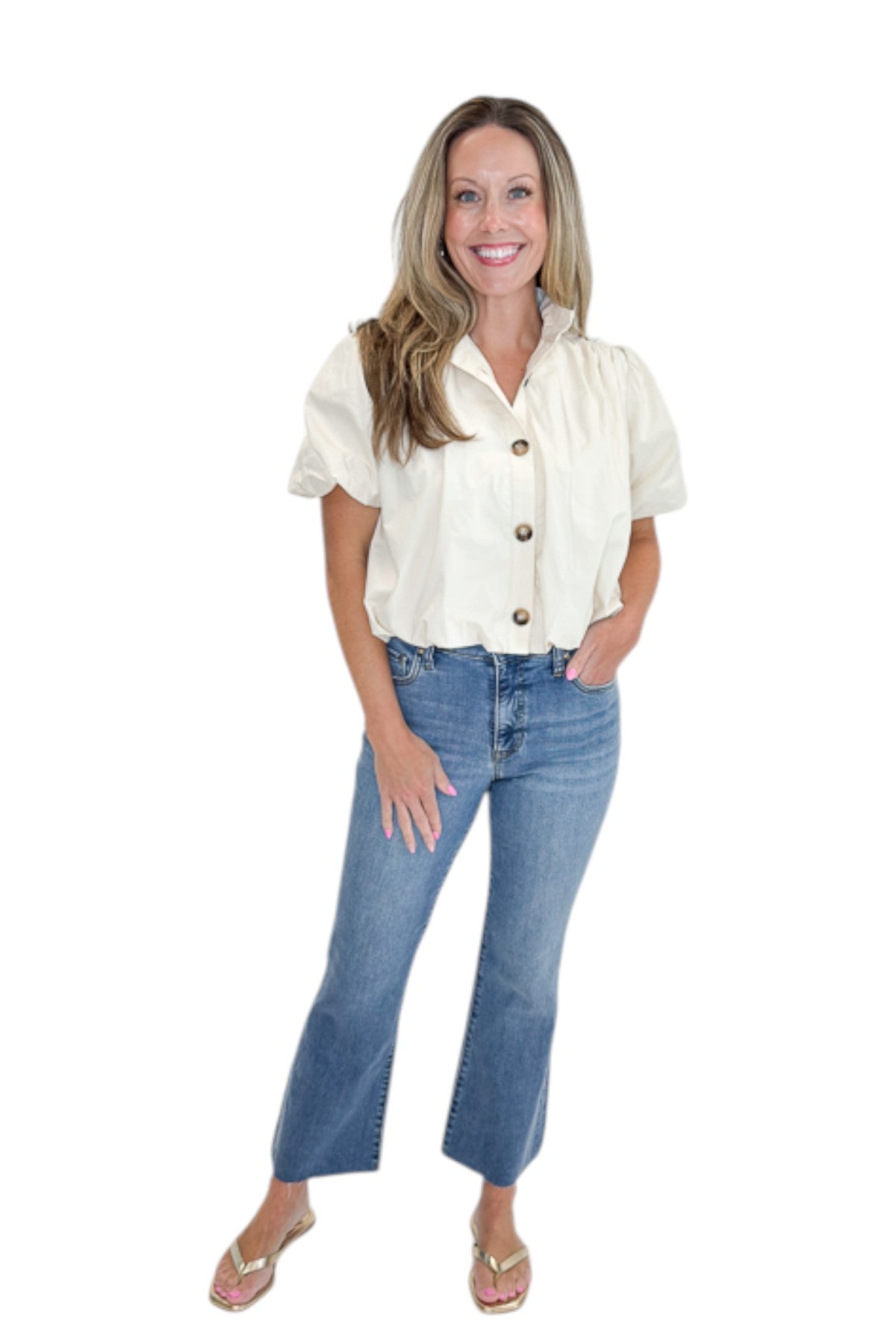 Front view of woman wearing Swagger Boutique’s Ecru Bubble Hem Button Up Top by Entro with jeans against white studio background.
