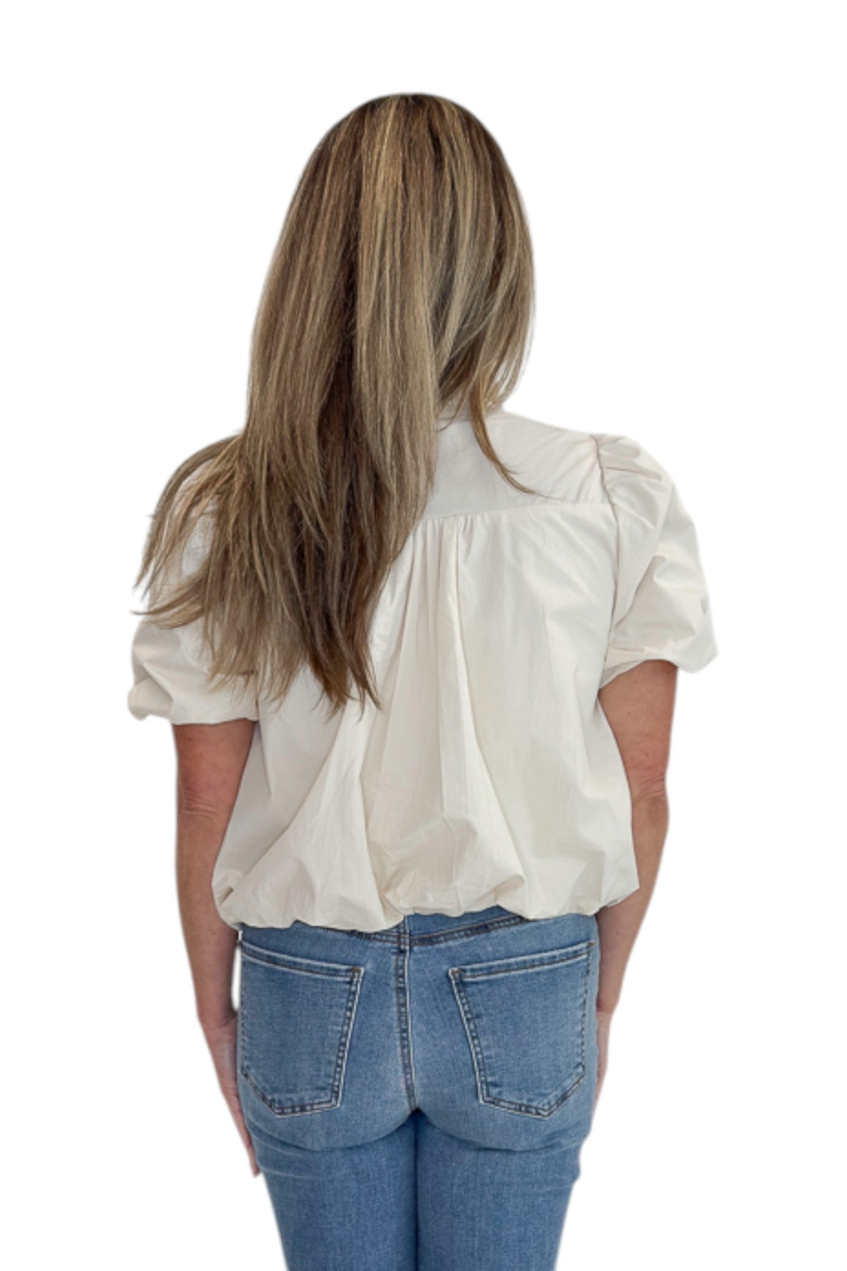Back view of woman wearing Swagger Boutique’s Ecru Bubble Hem Button Up Top by Entro with jeans against white studio background.
