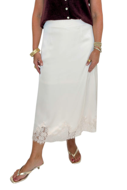 Front view of woman wearing Swagger Boutique’s Wine Sleeveless Button Up Sweater with Ecru Lace Lined Satin Skirt by Entro against white studio background.
