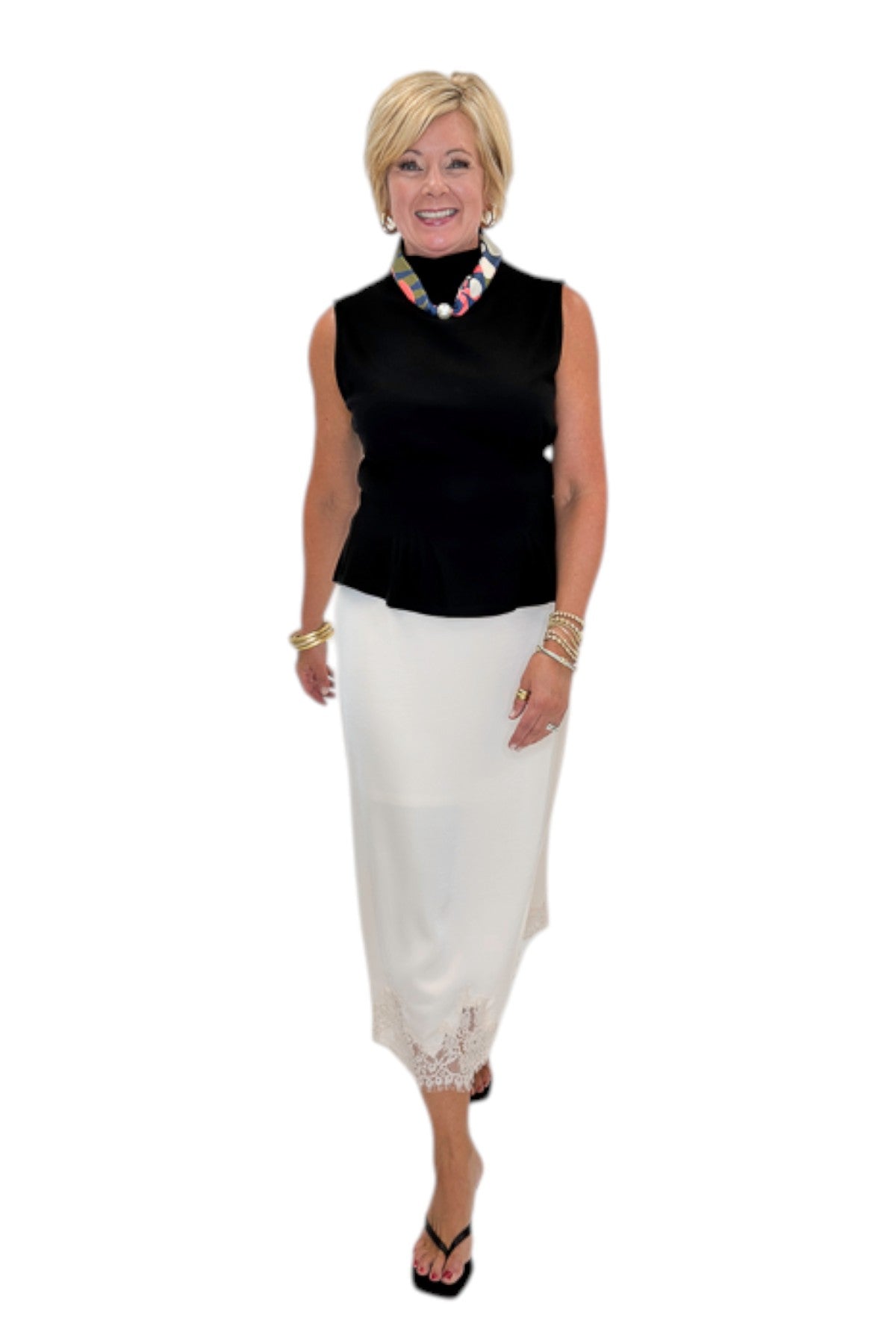 Front view of woman wearing Swagger Boutique’s black top with Ecru Lace Lined Satin Skirt by Entro against white studio background.