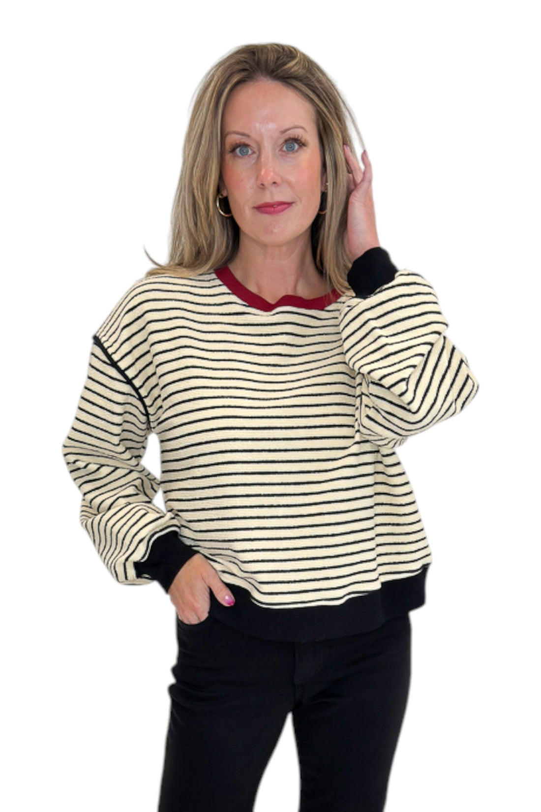 Front view of woman wearing Swagger Boutique’s Ecru &amp; Black Striped Sweatshirt by Entro with jeans against white studio background.