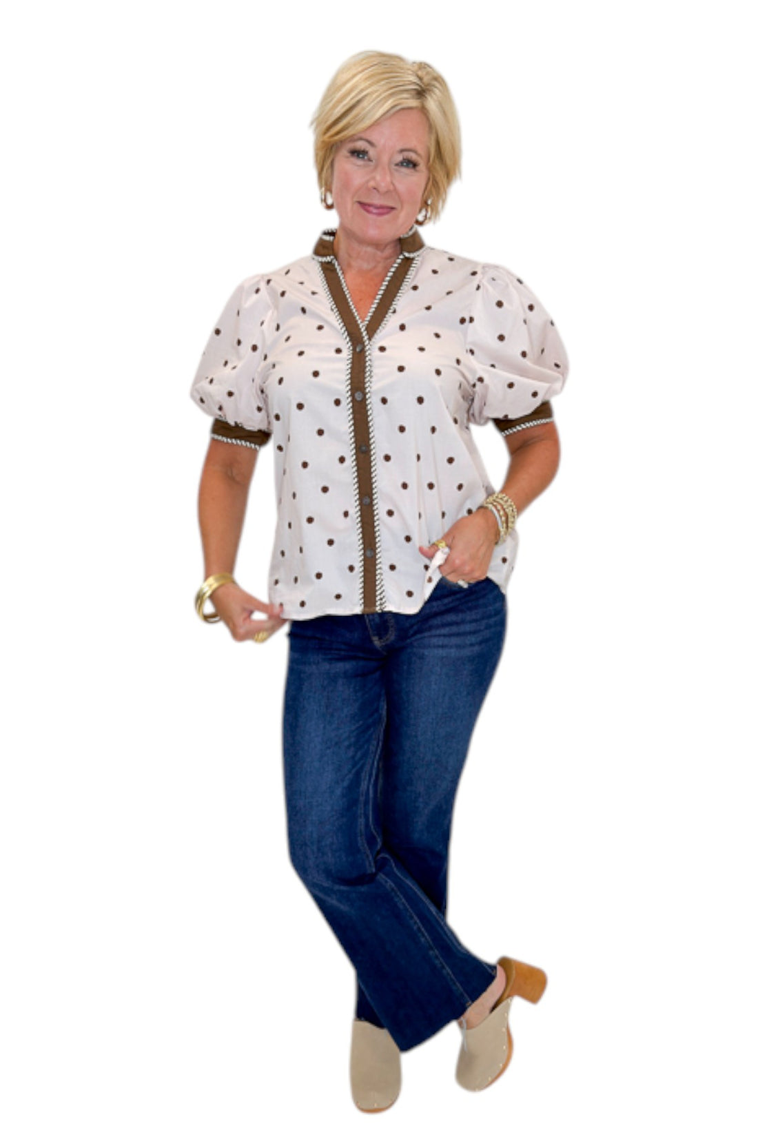 Front view of woman wearing Swagger Boutique’s Ecru &amp; Brown Polka Dot Button Up Top by Entro with jeans against white studio background.
