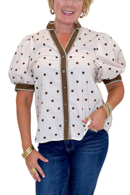 Front detail view of woman wearing Swagger Boutique’s Ecru &amp; Brown Polka Dot Button Up Top by Entro with jeans against white studio background.