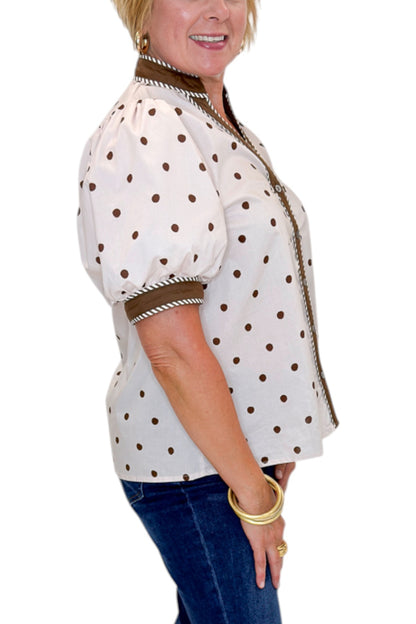 Side detail view of woman wearing Swagger Boutique’s Ecru &amp; Brown Polka Dot Button Up Top by Entro with jeans against white studio background.
