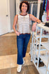 Front view of woman wearing Swagger Boutique’s Ecru & Brown Striped Tank with jeans at the store.