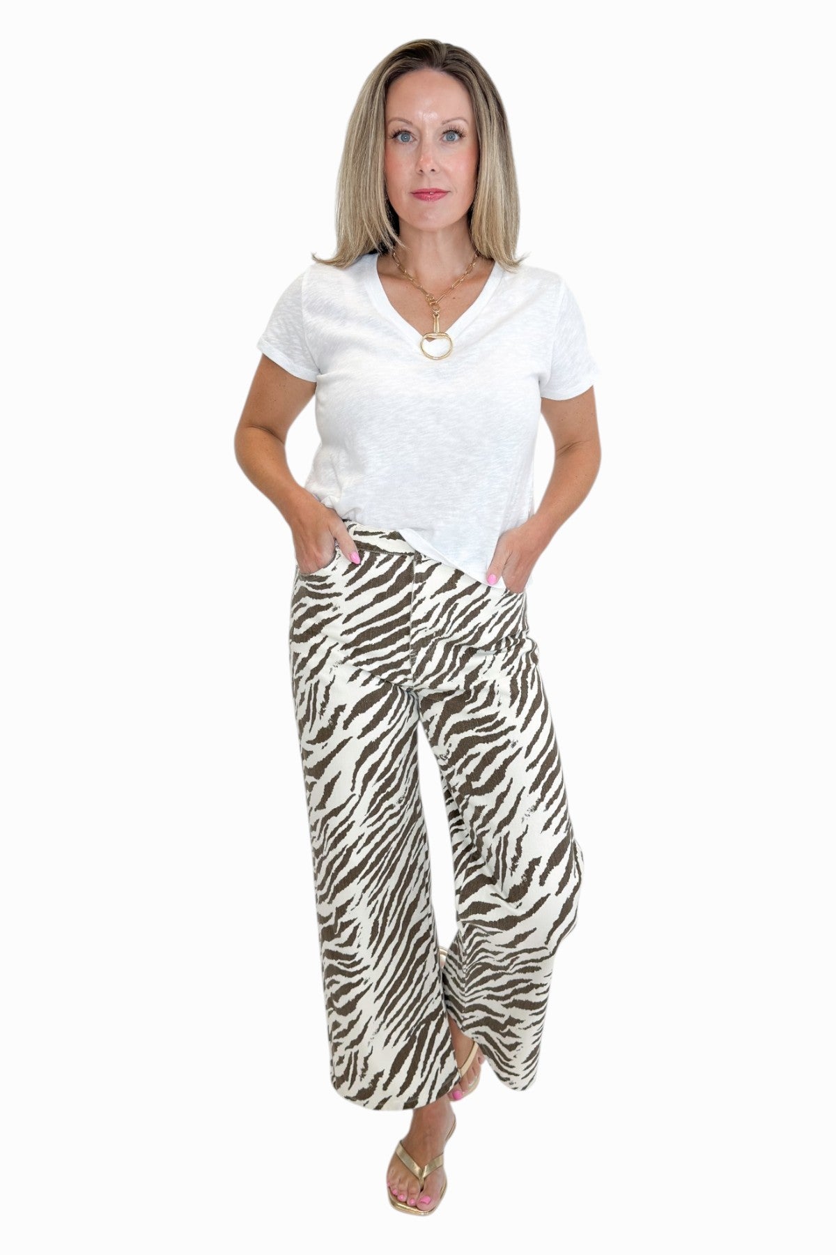Front view of woman wearing Swagger Boutique’s  zebra jeans against white studio background.