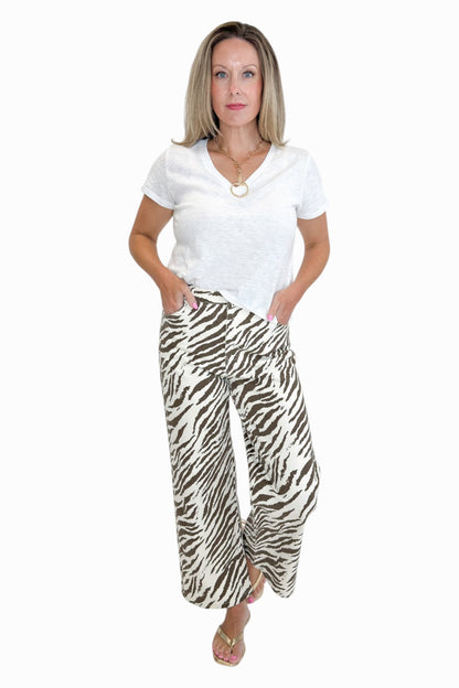 Front view of woman wearing Swagger Boutique’s  zebra jeans against white studio background.
