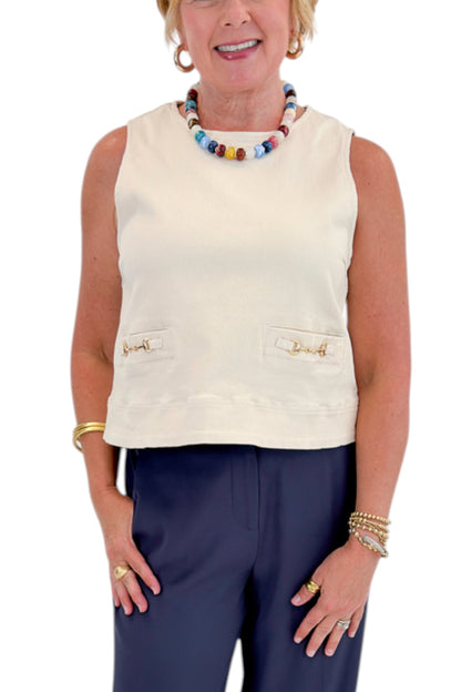 Front detail view of woman wearing Swagger Boutique’s Ecru Horsebit Buckle Tank by Entro with Navy High Waisted Trousers by Skies Are Blue against white studio background.