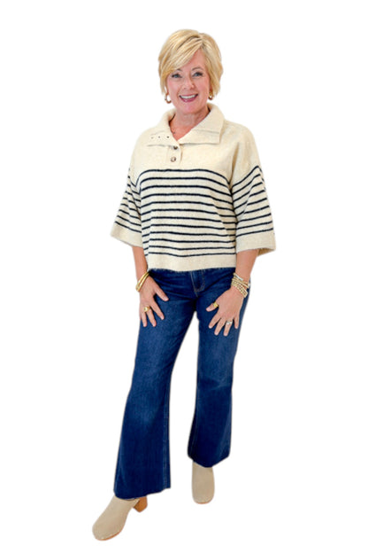 Front view of woman wearing Swagger Boutique’s Ecru &amp; Navy Striped 3/4 Sleeve Sweater by Entro with jeans against white studio background.