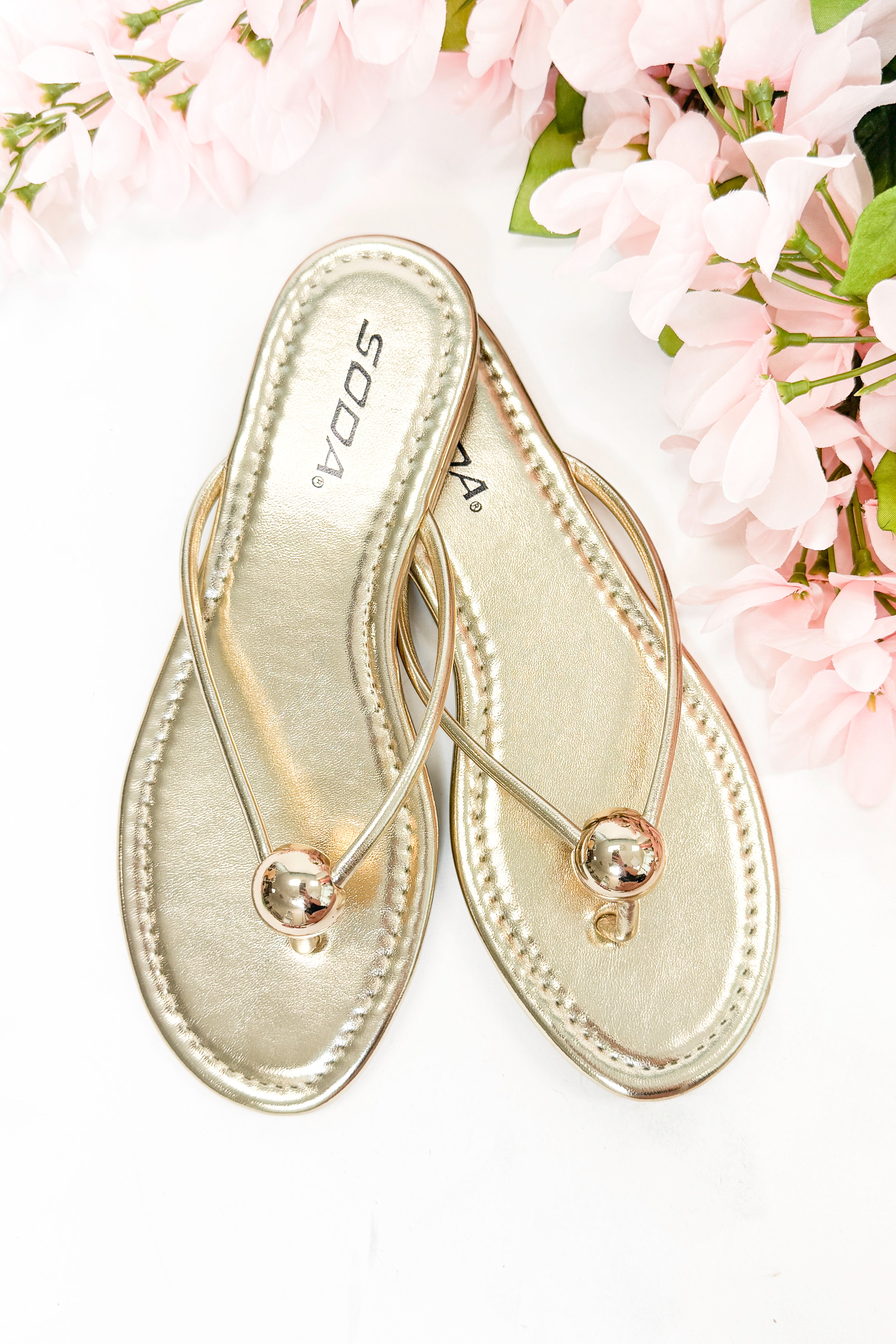 Elwood- Gold Ball Flip Flop against white studio background