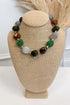 front view of multicolor nugget shaped beaded necklace with gold accents on bust 