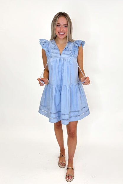 Front view of woman wearing Light Blue Eyelet Detail Dress with sandals against white studio background.