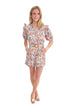 Front view of woman wearing Orange Floral & Lace Romper With Belt against white studio background.