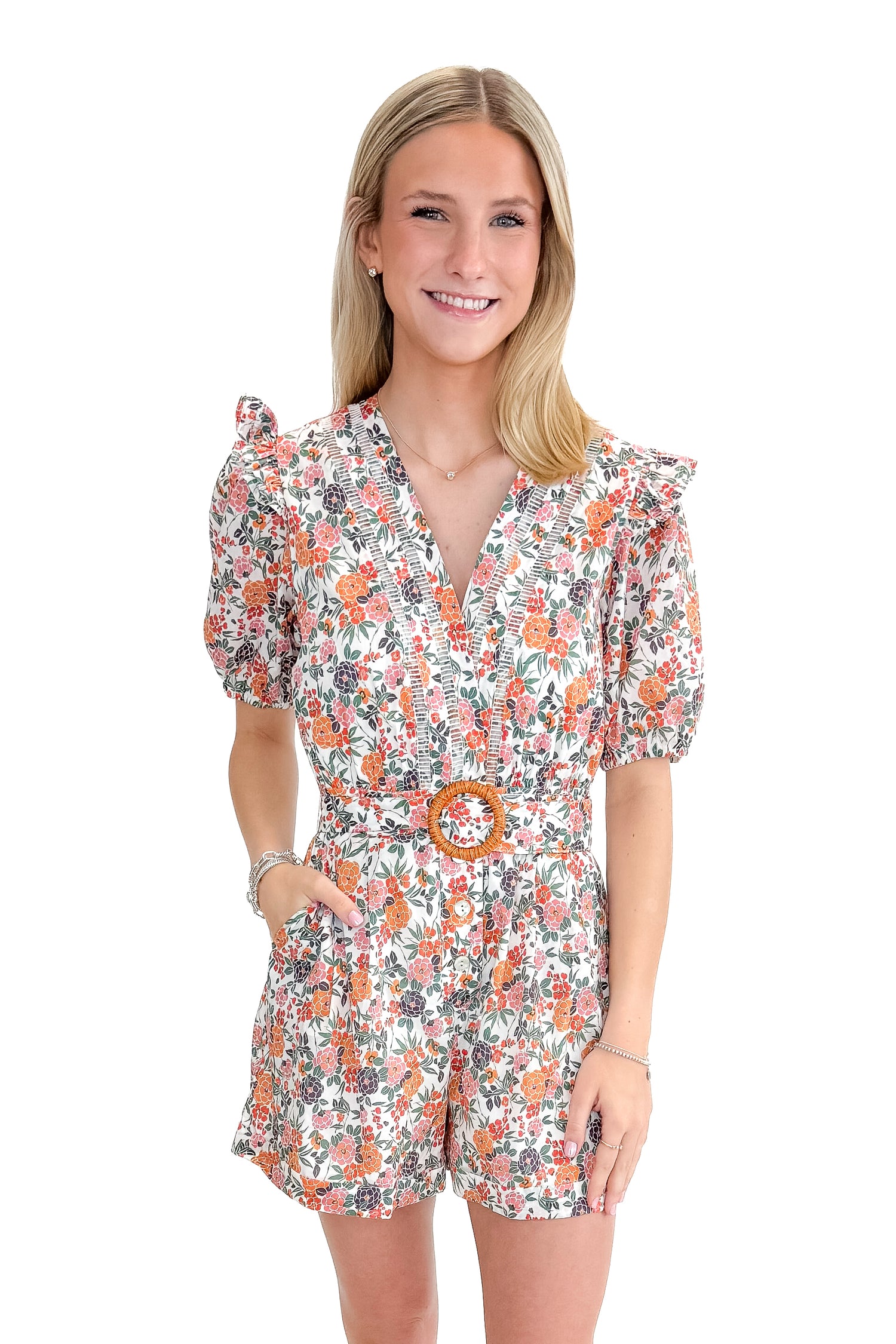 Front view of woman wearing Orange Floral &amp; Lace Romper With Belt against white studio background.