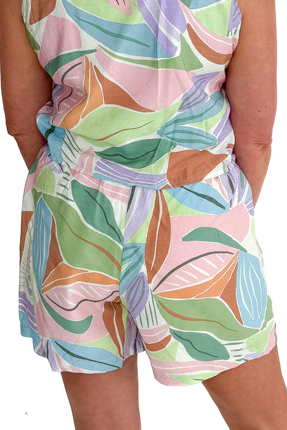 Back detail view of woman wearing Multi Leaf Print Shorts with matching tank against white studio background.