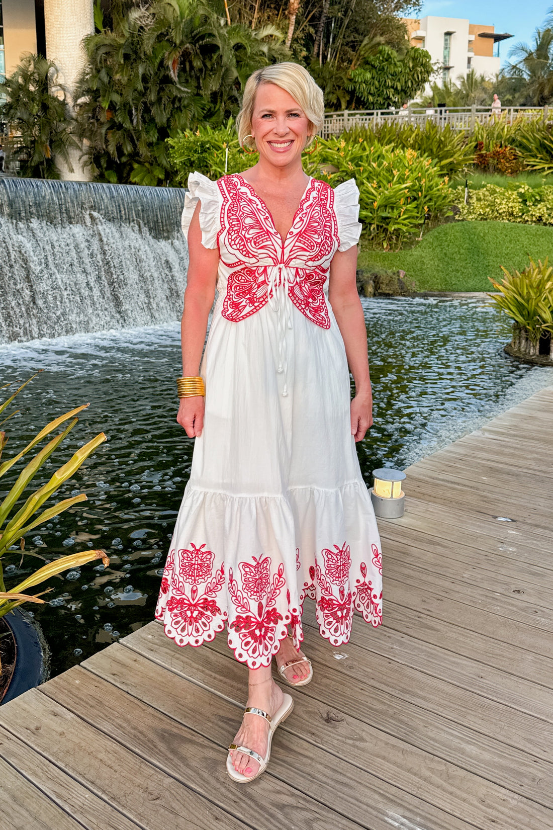 Front view of woman wearing Red &amp; White Butterfly Embroidered Midi Dress by Fate outside on a dock.