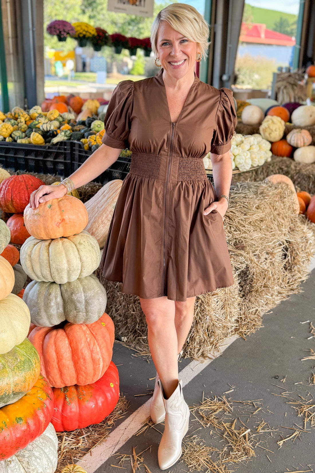 Woman wearing Just My Luck Brown Smocked Waist Center Zip Dress by Entro - front view showing smocked waist detail and center zip closure