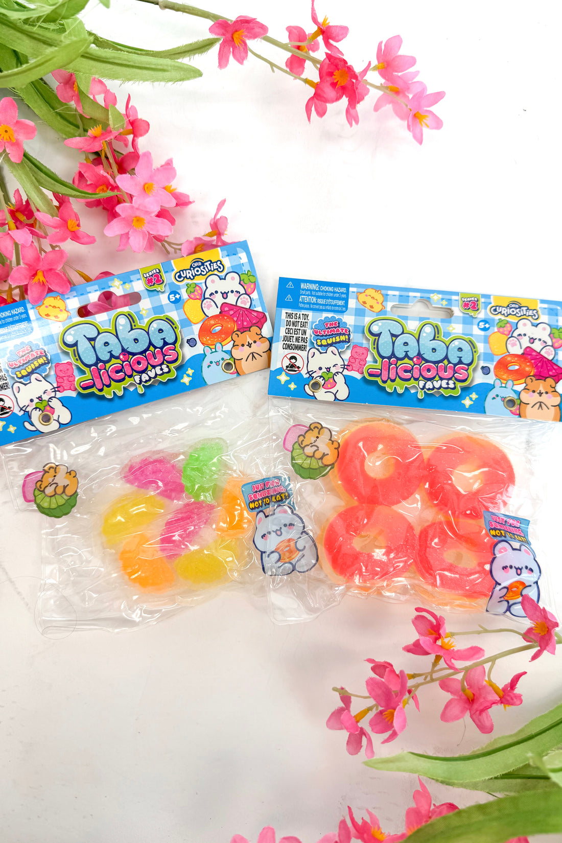 Packages of Taba delicious gummy candies with floral decorations on a white background