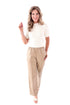 Front view of woman wearing Macchiato Faux Leather Pants and sweater against white studio background.