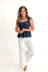 Front view of woman wearing Cream Stitch Detail Flare Jeans by Fate with top against white studio background.