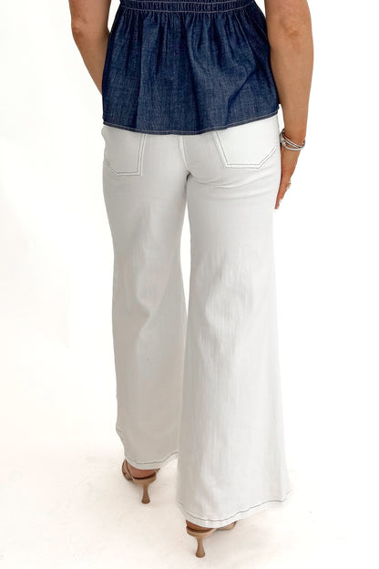Back view of woman wearing Cream Stitch Detail Flare Jeans by Fate with top against white studio background.