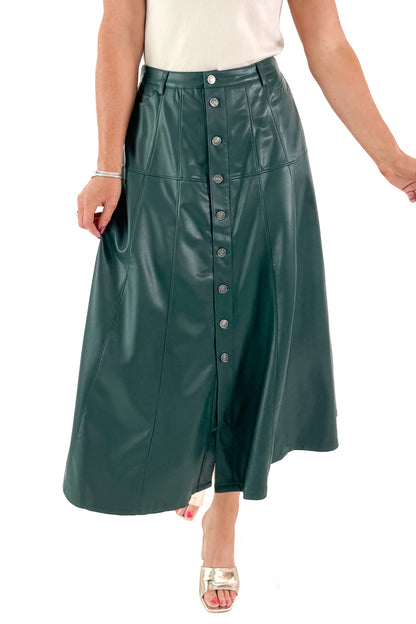 Front view of woman wearing Hunter Green Faux Leather Midi Skirt with top against white studio background.