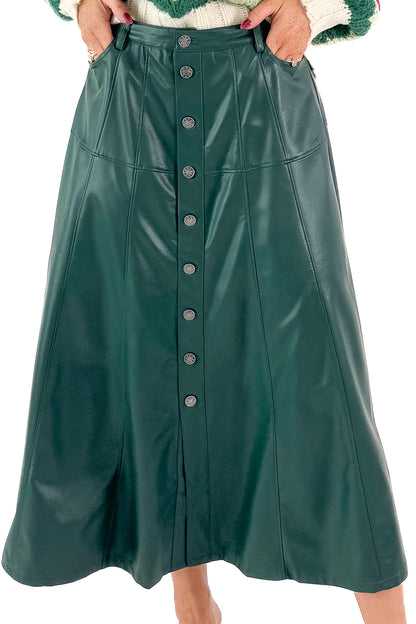 Front detailed view of woman wearing Hunter Green Faux Leather Midi Skirt with top against white studio background.