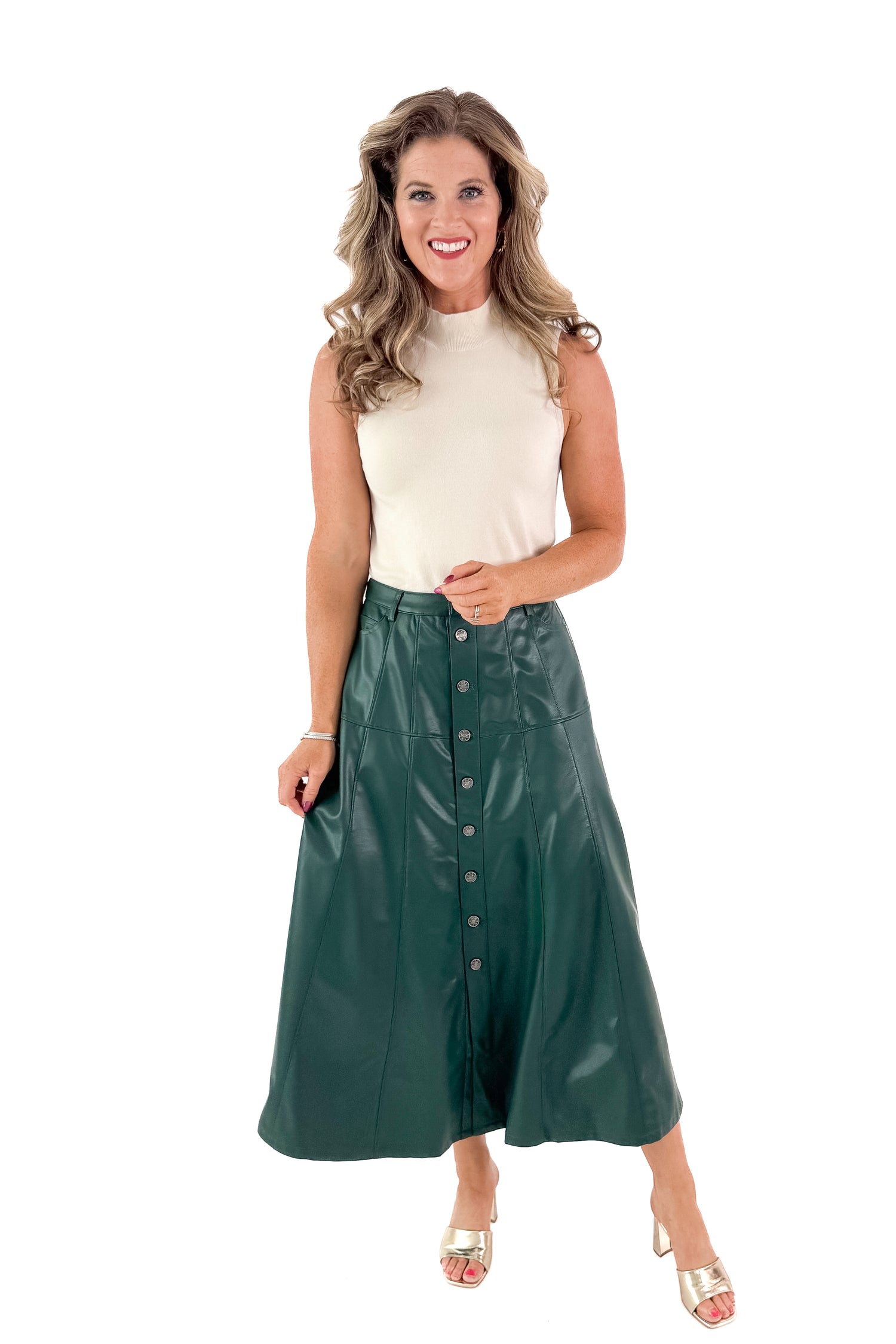 Front view of woman wearing Hunter Green Faux Leather Midi Skirt with top against white studio background.