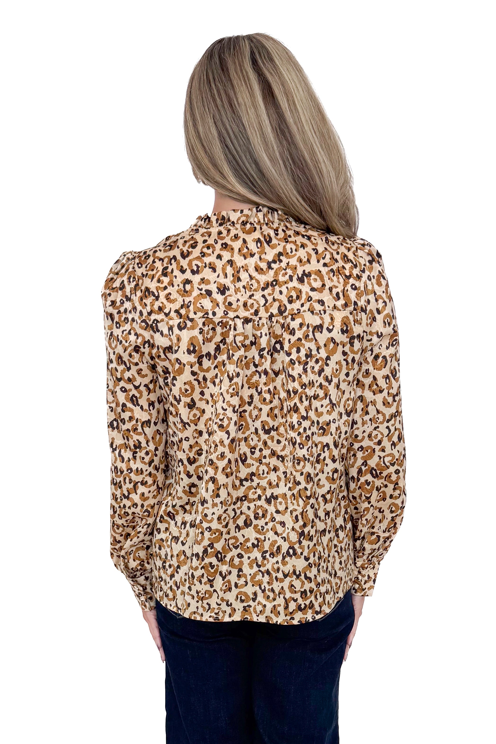 Back view of woman in a studio wearing Taupe Leopard Long Sleeve Top by Fate and jeans against a white background. 