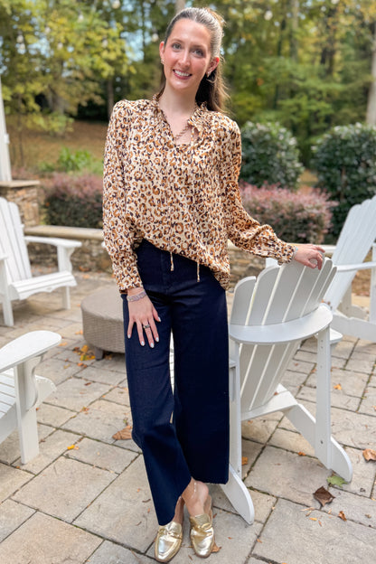 Woman outside wearing Taupe Leopard Long Sleeve Top by Fate and jeans. 