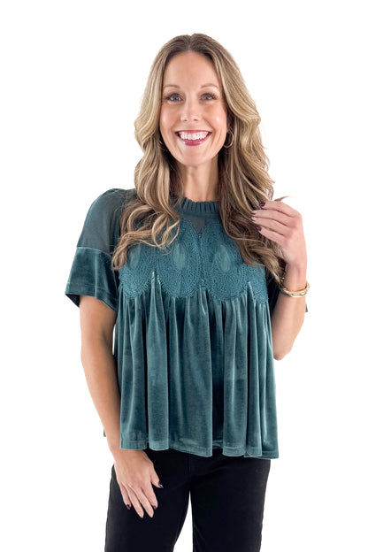 Front view of woman wearing Teal Velvet With Lace Applique Top with jeans against white studio background.