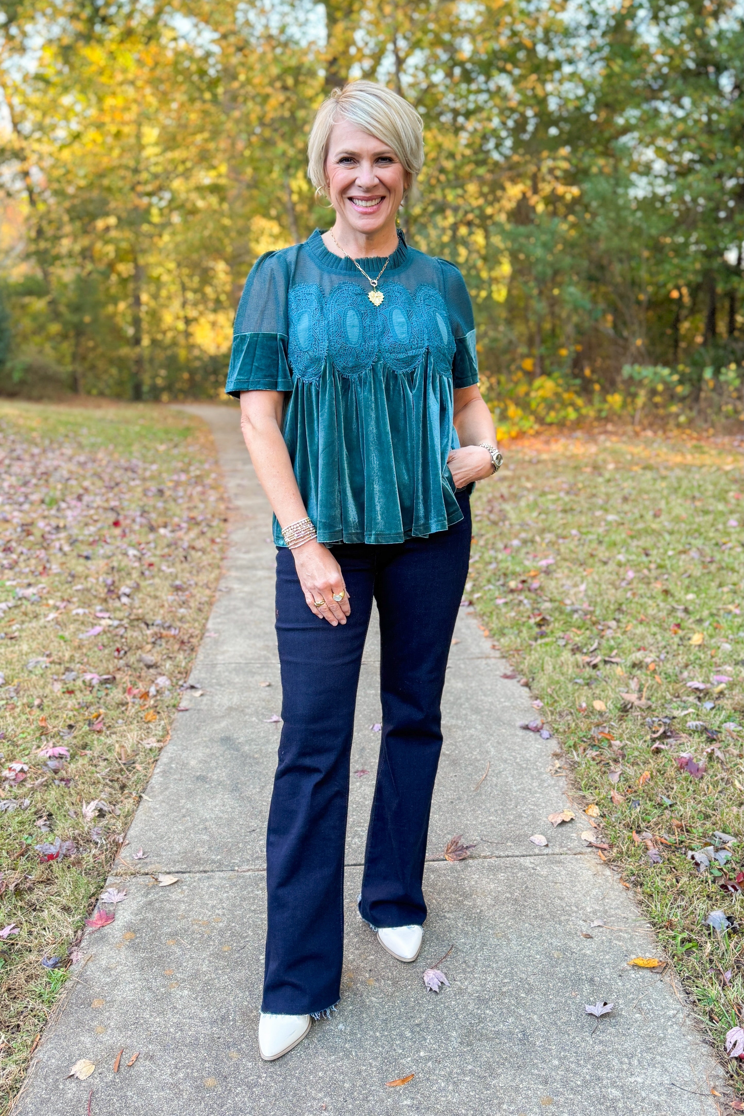 Front view of woman wearing Teal Velvet With Lace Applique Top with jeans outside.
