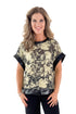 Front view of woman wearing Black & Gold Metallic Abstract Print Top with jeans against white studio background.