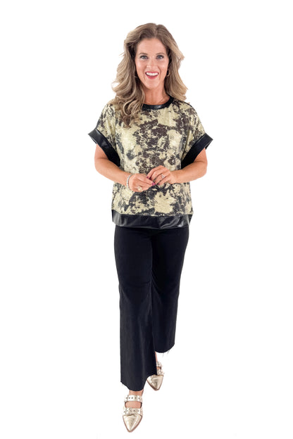 Front view of woman wearing Black &amp; Gold Metallic Abstract Print Top with jeans against white studio background.