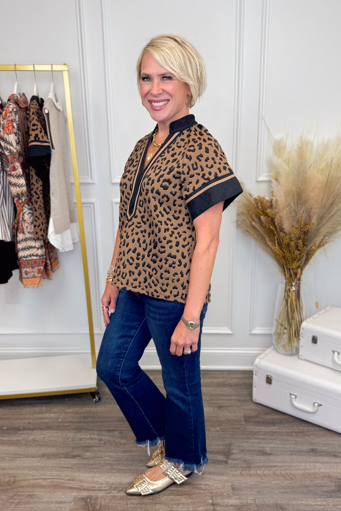 Woman wearing Looking For You Brown Leopard Textured Top by THML - side view showing leopard print pattern and textured fabric