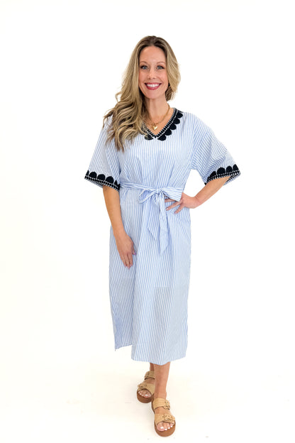 Front view of woman wearing Blue Striped Embroidery Accent Midi Dress with sandals against white studio background.