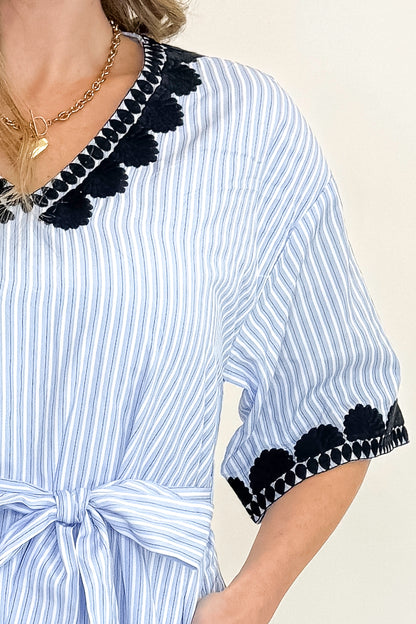 Front detail view of woman wearing Blue Striped Embroidery Accent Midi Dress with sandals against white studio background.