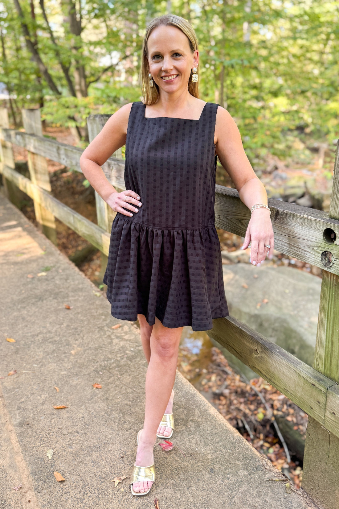 Woman outside wearing Black Square Neck Polka Dot Detail Dress with trees in the background.
