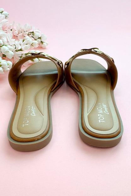 Back view of Gelato- Tan Buckle Detail Sandals against pink studio background.