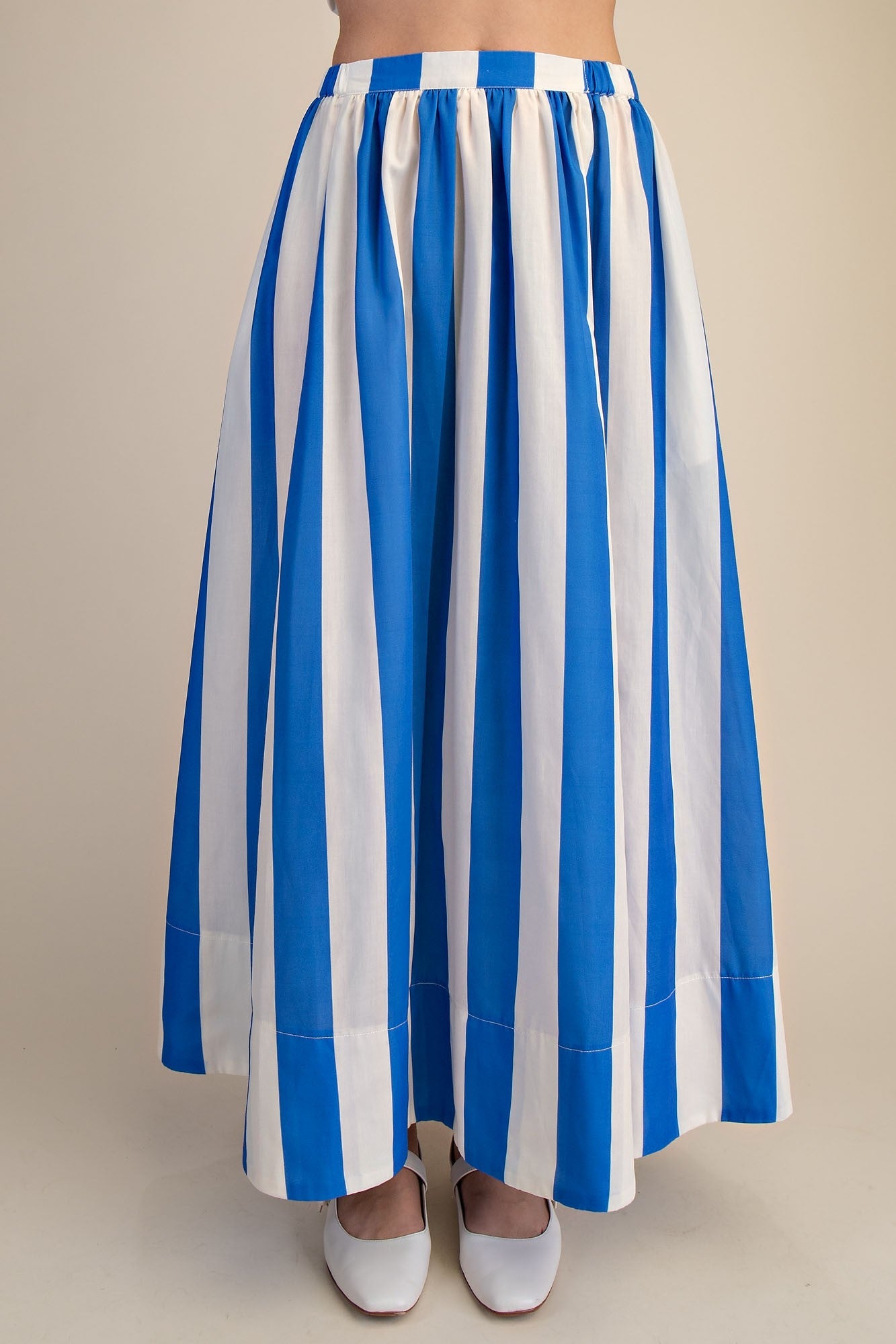 Front view of woman wearing Blue &amp; White Striped Skirt against studio background.