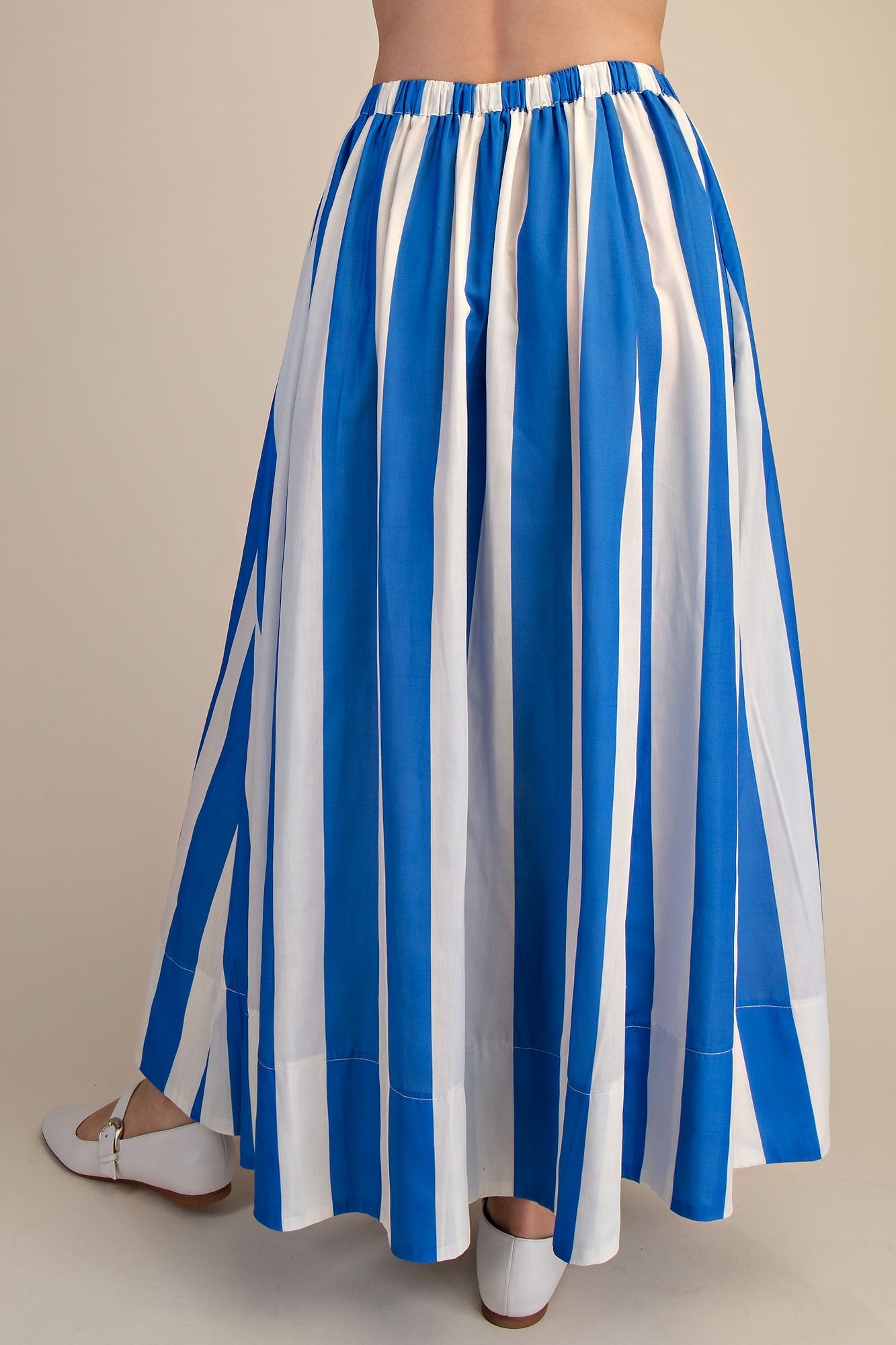 Back view of woman wearing Blue &amp; White Striped Skirt against studio background.