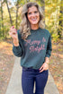 Front view of woman wearing Garland Green Bright Sunday Sweatshirt with jeans outside.