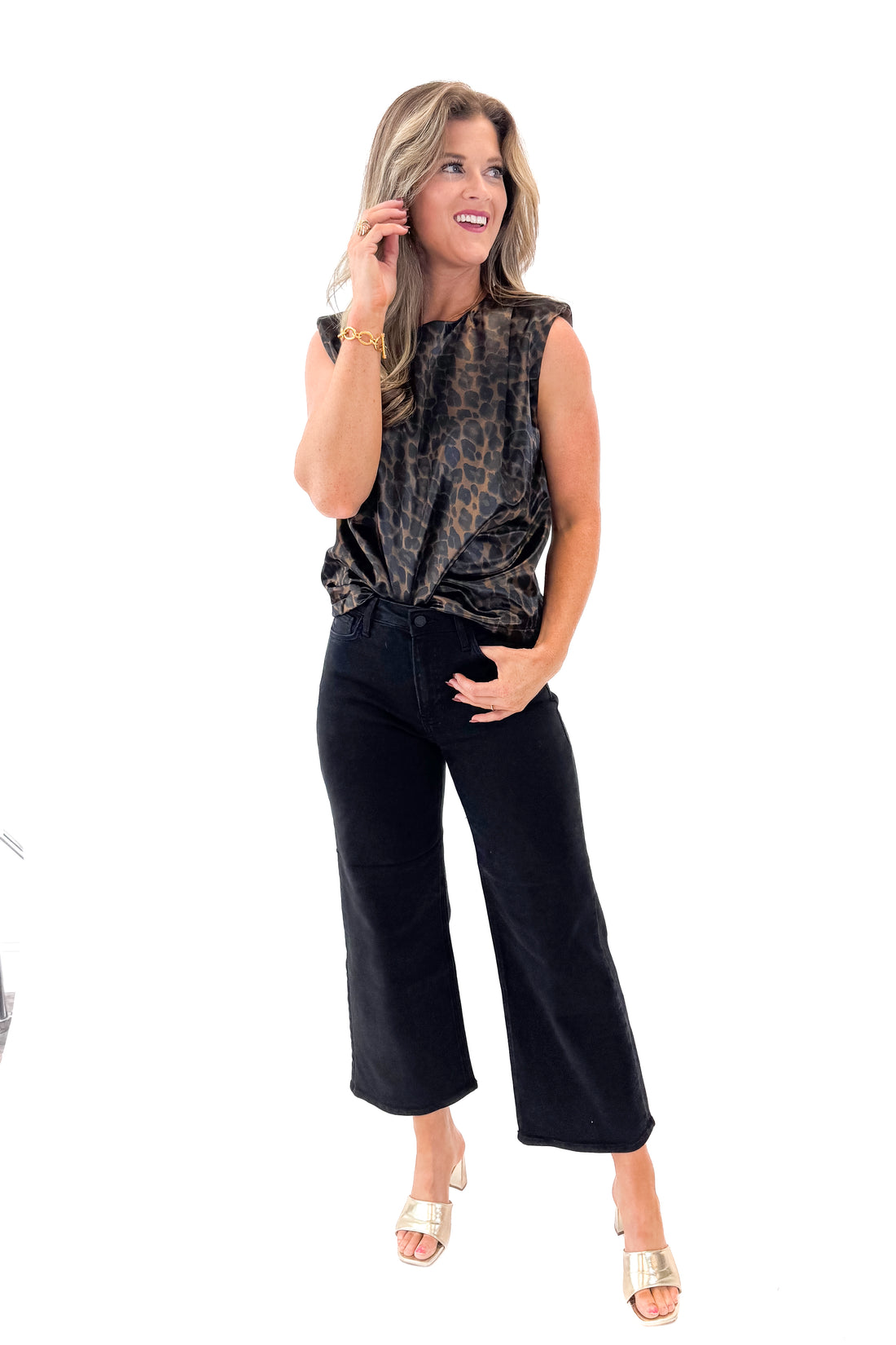 Front view of woman wearing Leopard Satin Sleeveless Top with jeans against white studio background.
